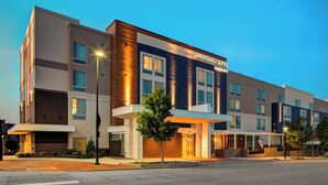 A modern hotel with a prominent sign reading "Springhill Suites Marriott." It features a multi-story structure with a flat roof, large windows, and a well-lit entrance. - SpringHill Suites by Marriott Kansas City Lenexa City Center (Lenexa)