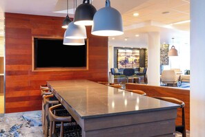 A modern kitchen with a long island, bar stools, pendant lighting, and a large window. - Fairfield Inn and Suites by Marriott Moses Lake (Moses Lake)