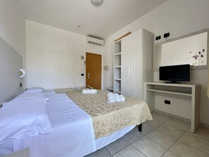 Eenvoudige driepersoonskamer | Een kluis op de kamer, een bureau, een laptopwerkplek