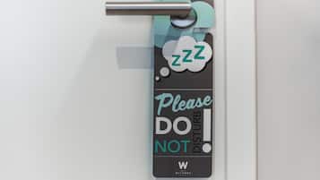 Una puerta con un cartel que dice “Por favor, NO MOLESTAR” y un símbolo de una persona durmiendo con ‘zzz’ indicando sueño.