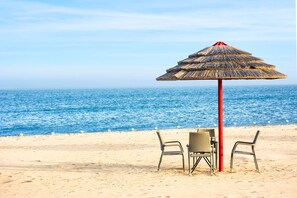 Private beach, beach umbrellas, beach towels