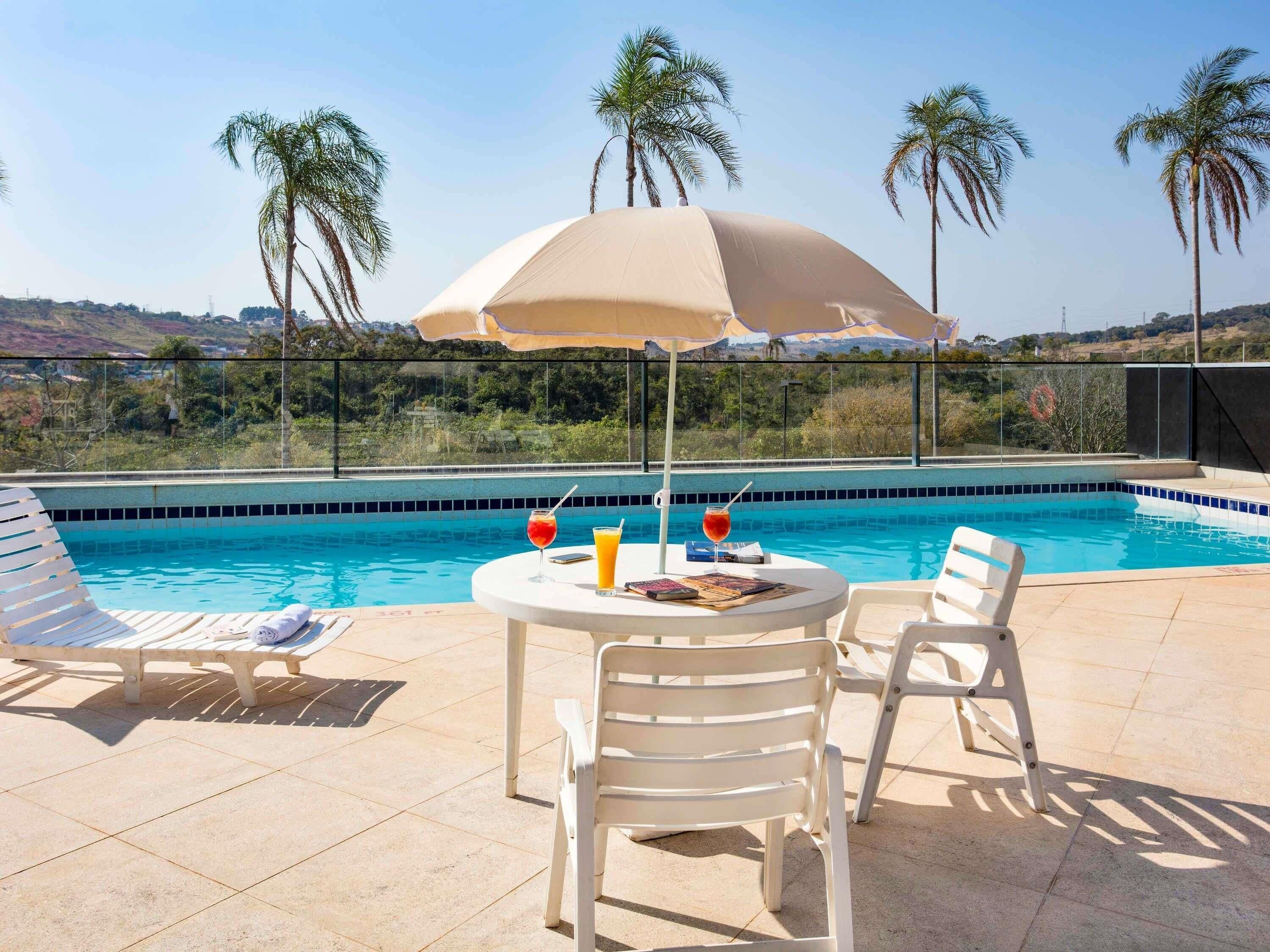 Outdoor pool, open 7:00 AM to 8:00 PM, pool umbrellas