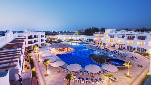 A hotel pool area with sun loungers, umbrellas, and a central water feature. - Old Vic Sharm Resort (Sharm El Sheikh)