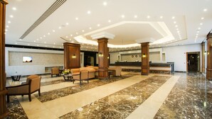A spacious lobby with a reception desk, comfortable seating, and a marble floor. - Old Vic Sharm Resort (Sharm El Sheikh)