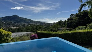 A swimming pool with a clear view of a cityscape and mountains in the background. - Kamala Heights (Kamala)
