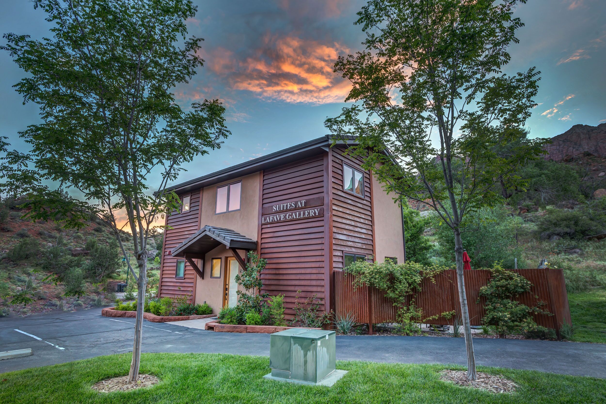 A two-story building with a sign reading "Suites at Lafave Gallery."