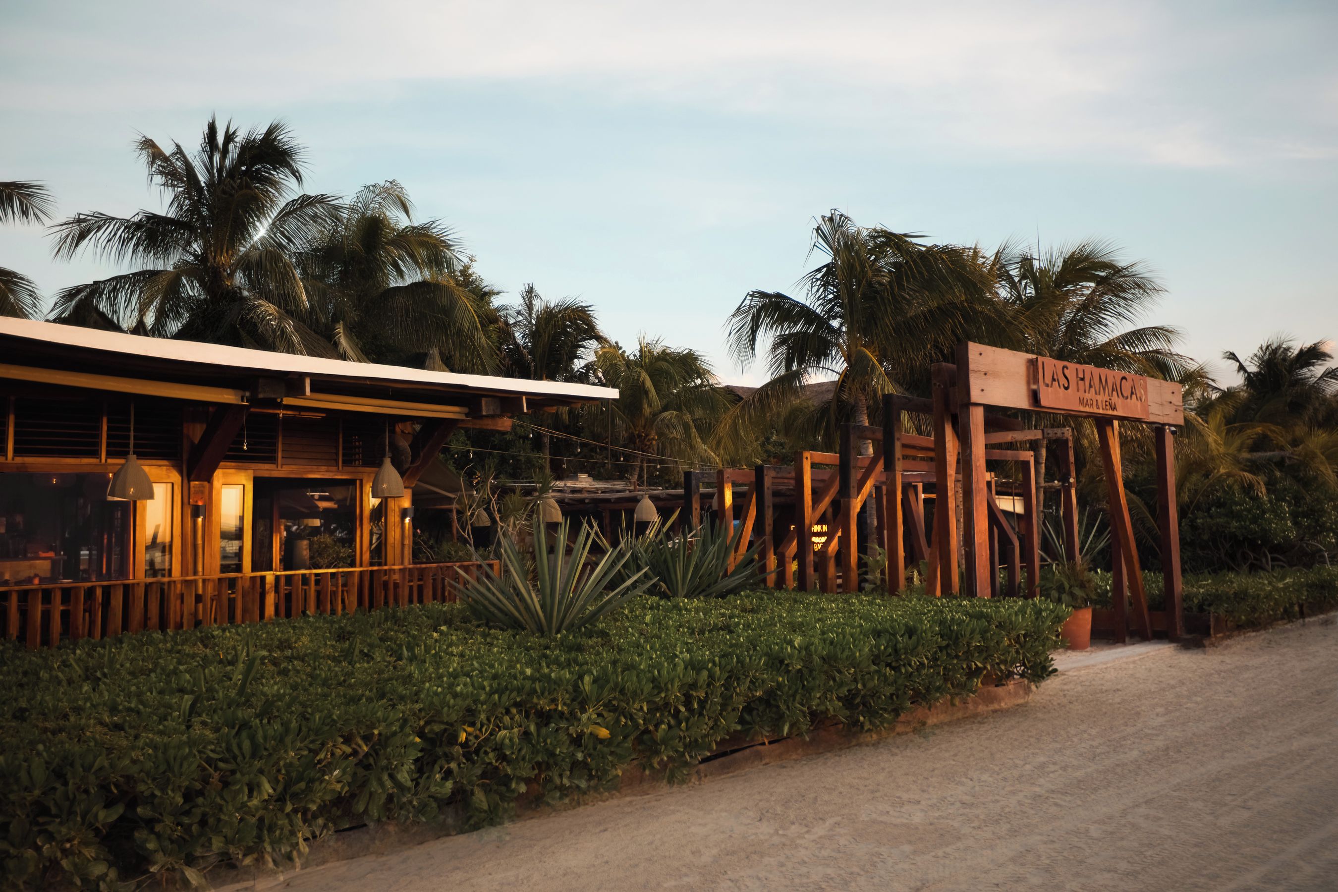 A wooden sign with 'Las Hamacas' written on it, indicating a location or establishment.