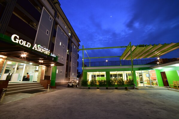 A hotel with a prominent "Gold Airport Suites" sign, a covered outdoor area, and a staircase leading to the entrance. - Gold Airport Suites (Bangkok)