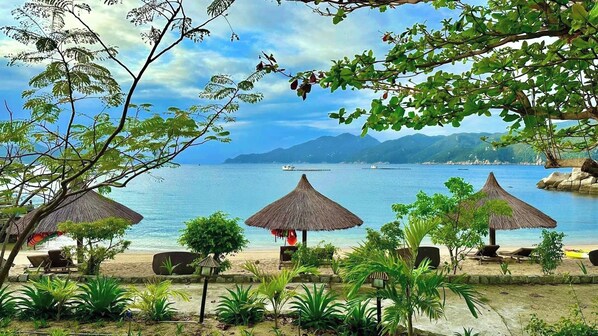 On the beach, sun loungers, beach umbrellas, beach towels - The Light Coral Island Resort (Van Ninh)