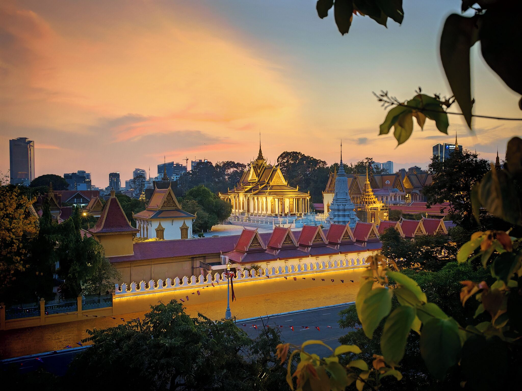 A traditional temple complex with multiple structures, including a central building with a golden roof and smaller buildings with red roofs.