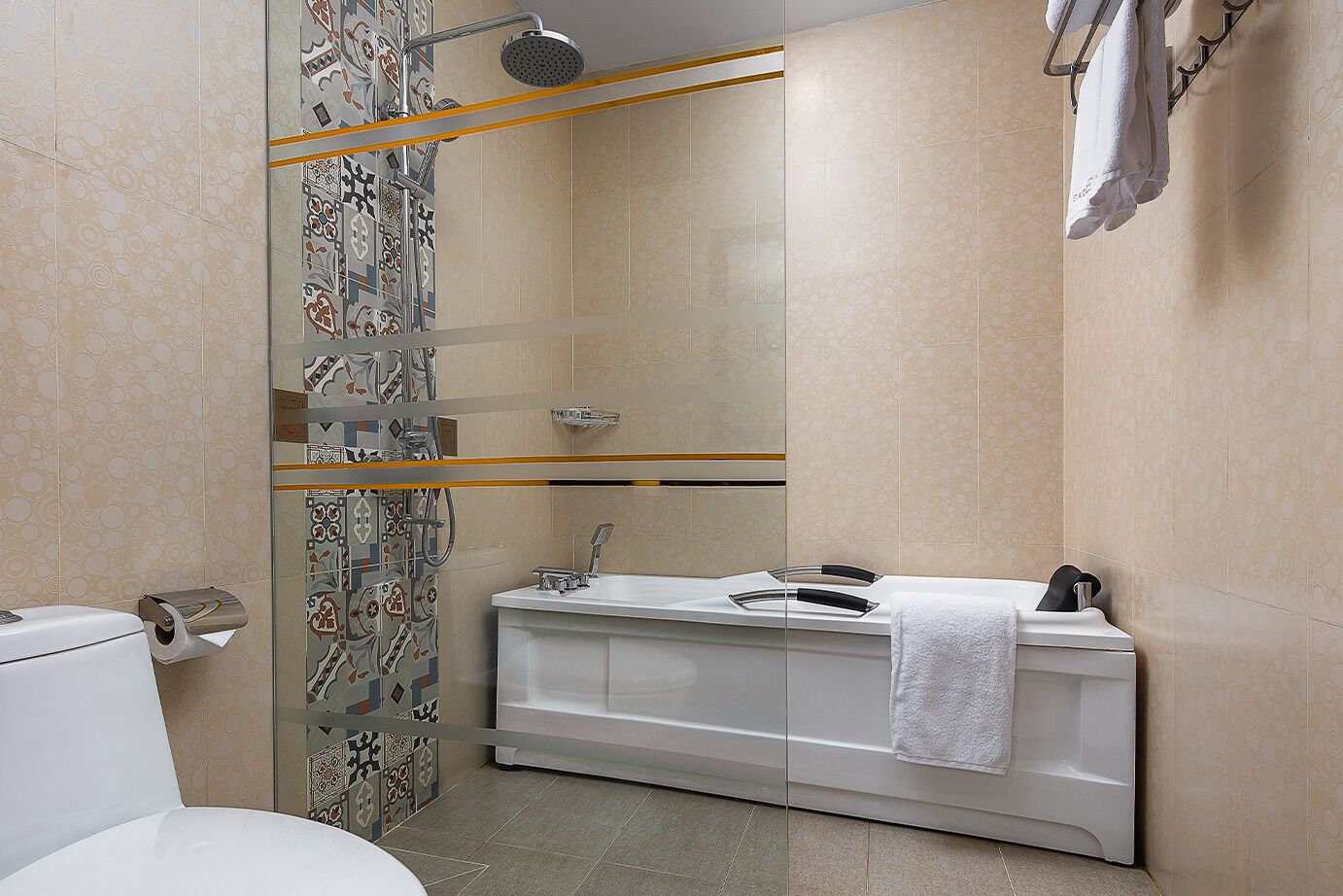 A modern bathroom with a shower, toilet, and sink.