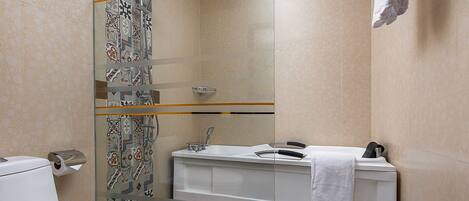 A modern bathroom with a shower, toilet, and sink.