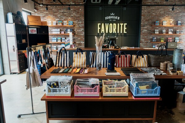 A store with a brick wall and shelves displaying various items. - Playce Camp Jeju (Seogwipo)