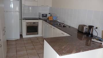 3 Bedroom 2 Bathroom Self Contained Apartment | Private kitchen | Full-size fridge, microwave, oven, stovetop
