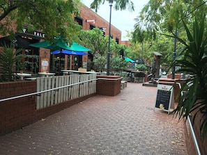 A brick building with outdoor seating and a sign for 'Stella Artois'. - City Escape 3BD in Adelaides East End 6 (Adelaide)