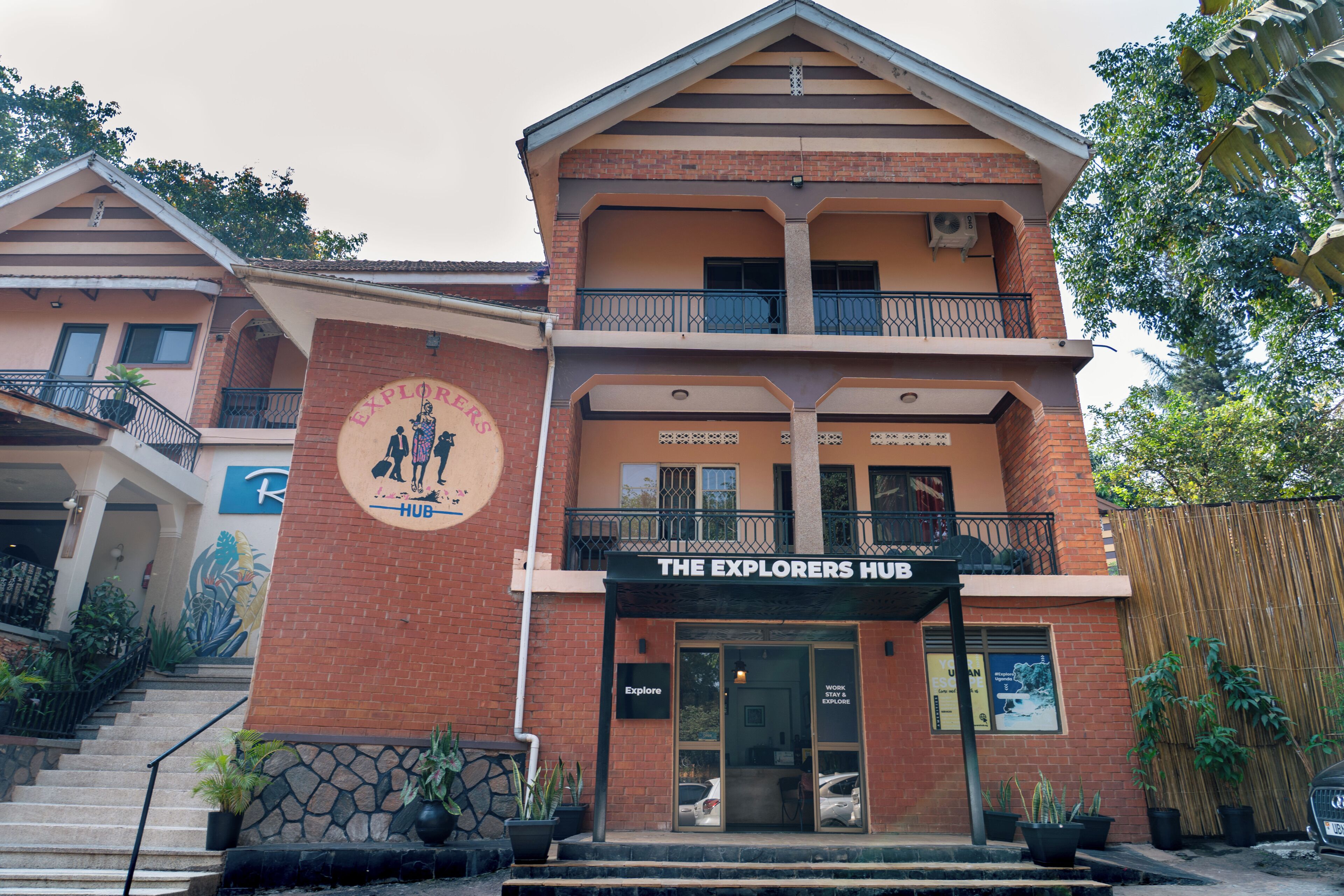 A two-story building with a sign reading 'The Explorers Hub.'
