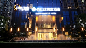 A hotel entrance with a fountain in front, a sign for 'BVSTIN BOUTIQUE HOTEL', and a modern building facade with illuminated windows. - Chengdu Bvstin Boutique Hotel (Chengdu)