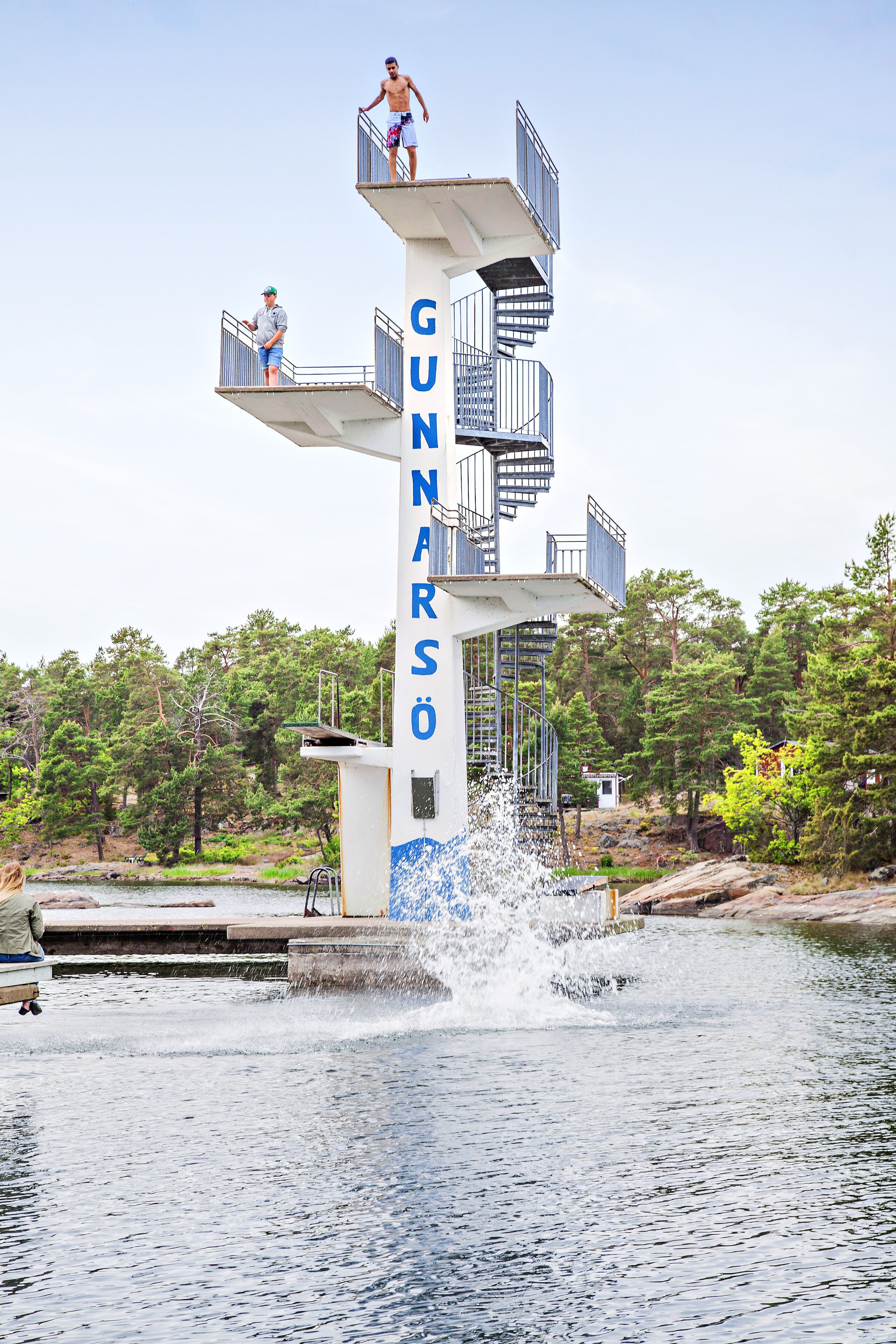 A diving platform with the name 'GUNARSO' and a staircase leading up to it.