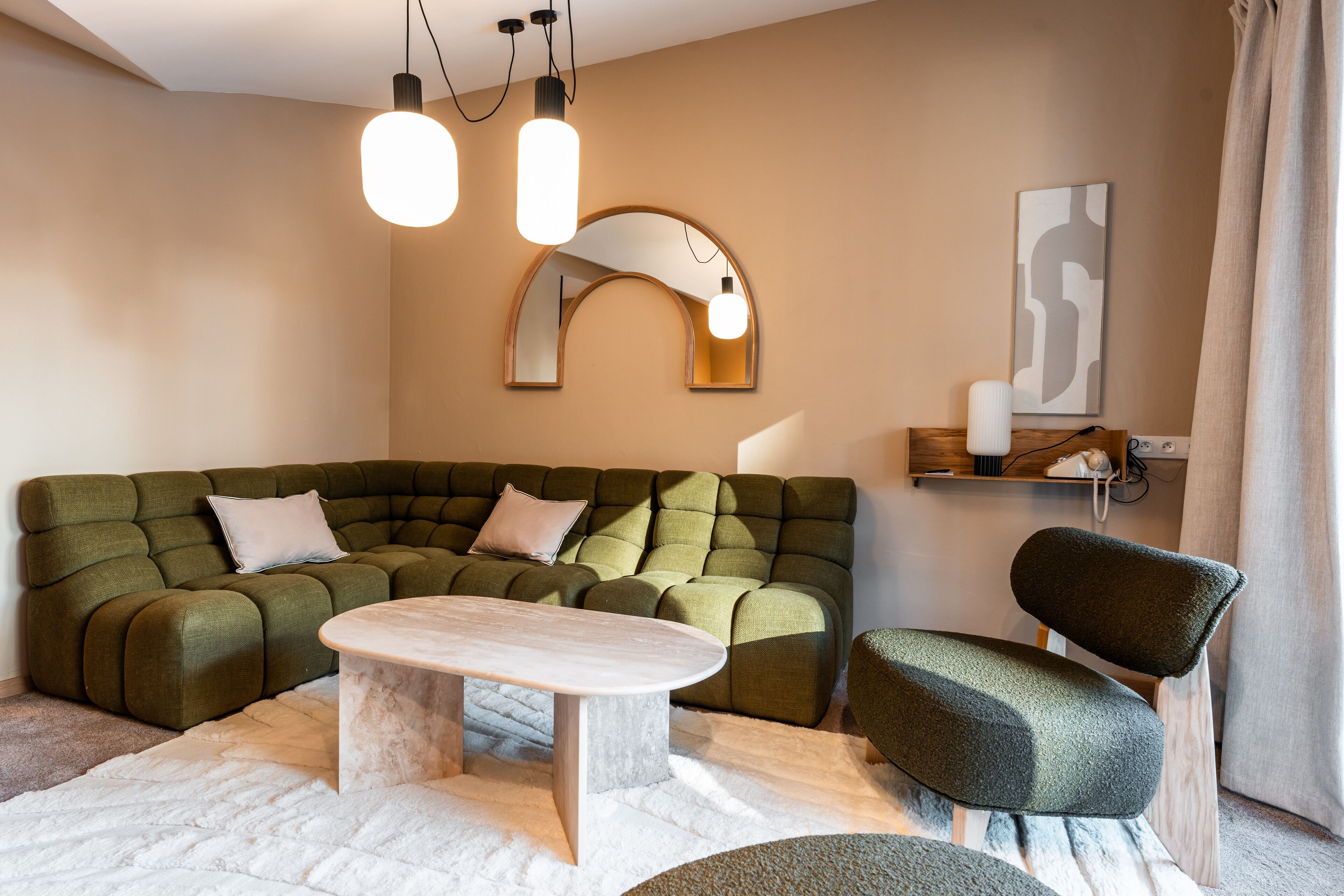 A modern living room with a sectional sofa, a coffee table, and a chair.