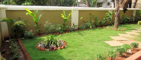 A well-maintained garden with a variety of plants and a neatly trimmed lawn.