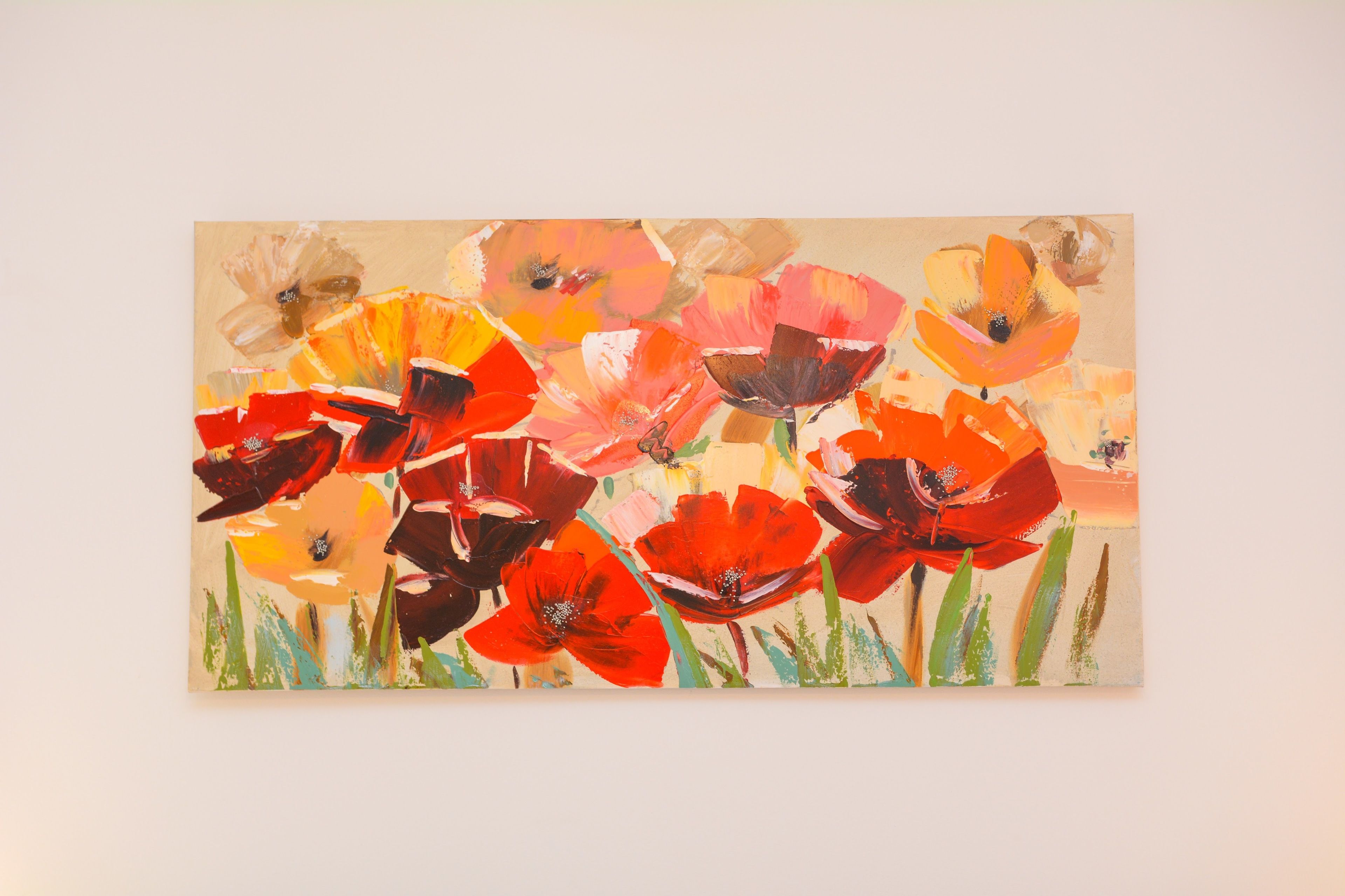 A painting of vibrant flowers on a wall.
