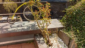 A building with a stone facade, a bicycle in the foreground, and a clear blue sky. - Villa Tummelchen (Cochem)