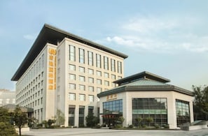 A modern building with a flat roof and multiple windows.