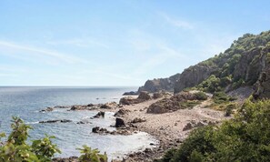 A coastal landscape with rocky terrain and vegetation. - First Camp Torekov (Torekov)