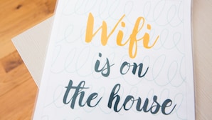 A printed sign with the text "Wifi is on the house" in a casual font. - Rethink Living - Hewitt Tower (Reading)