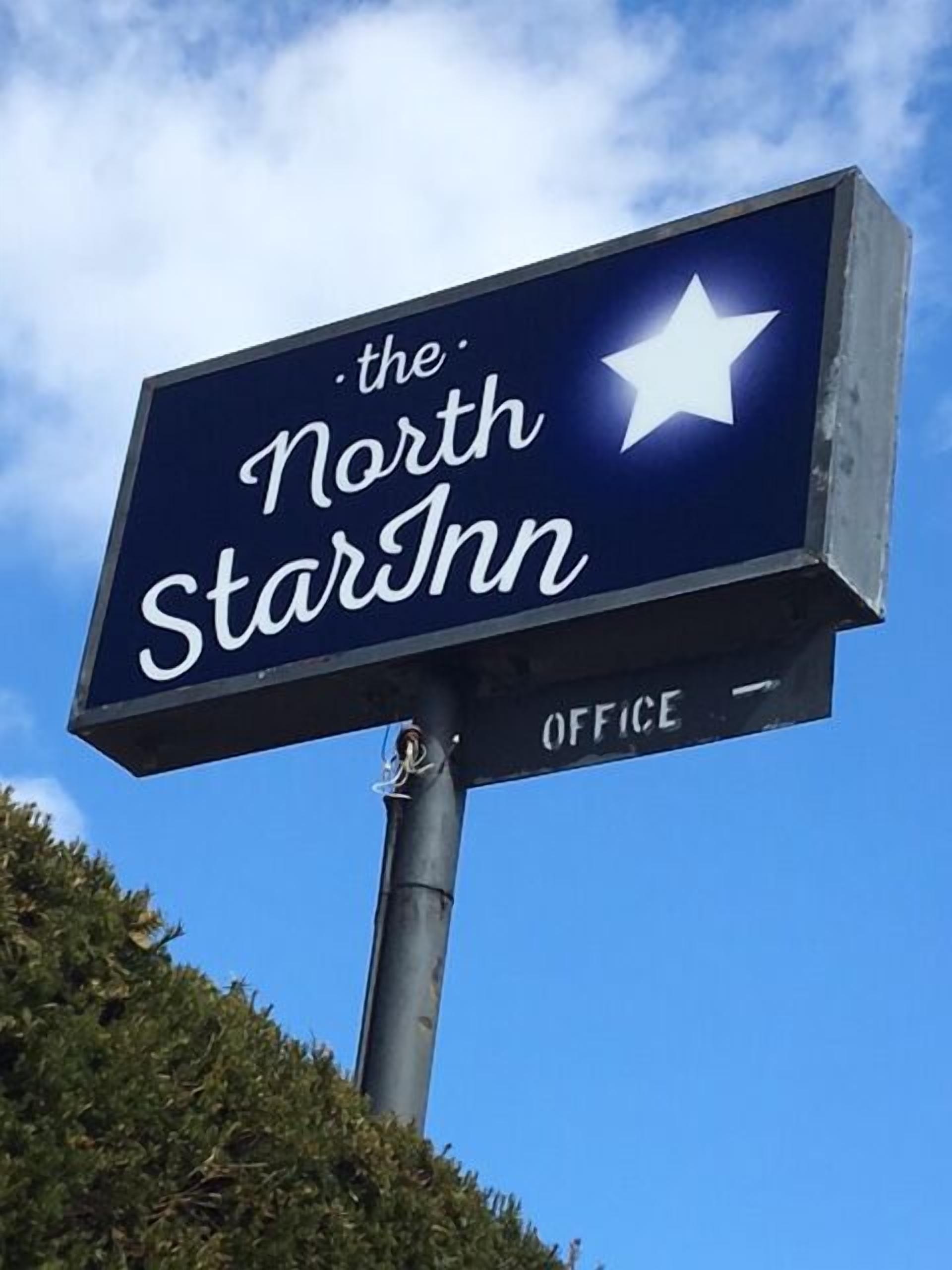 A sign for 'The North Star Inn' with a star symbol and the word 'OFFICE' below.