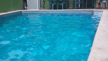 Seasonal outdoor pool, open 10:00 AM to 9:00 PM, pool umbrellas
