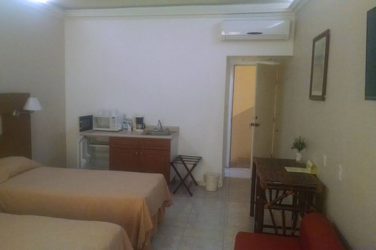 Apartment, 2 Bedrooms | Minibar, desk, laptop workspace, iron/ironing board