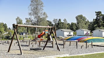 Children can play on the swing set and colorful slide in this well-maintained outdoor playground.