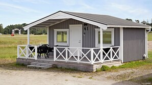 A small, single-story building with a porch, a door, and a window. - First Camp Karlstad (Karlstad)