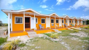 A row of single-story buildings with a flat roof, each with a front porch and a door. - Chesters Bonefish Lodge (Chesters)