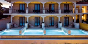 A hotel with a pool area, multiple balconies, and outdoor seating. - Agave Boutique Hotel (Zakynthos)