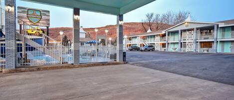 A motel with a sign for 'Expedition Lodge' and a covered parking area.