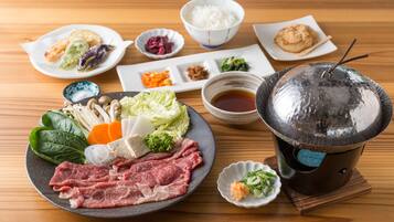 A traditional Japanese meal setup with various dishes and a hot pot.