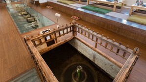 A modern hotel lobby with a glass floor, wooden railings, and a central staircase. - Racine Home Harie (Takashima)