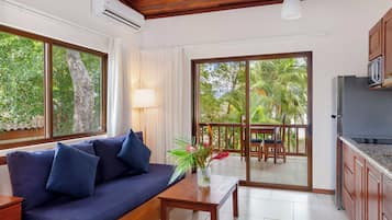 Suite, 1 King Bed, Beachfront | Living area | Flat-screen TV