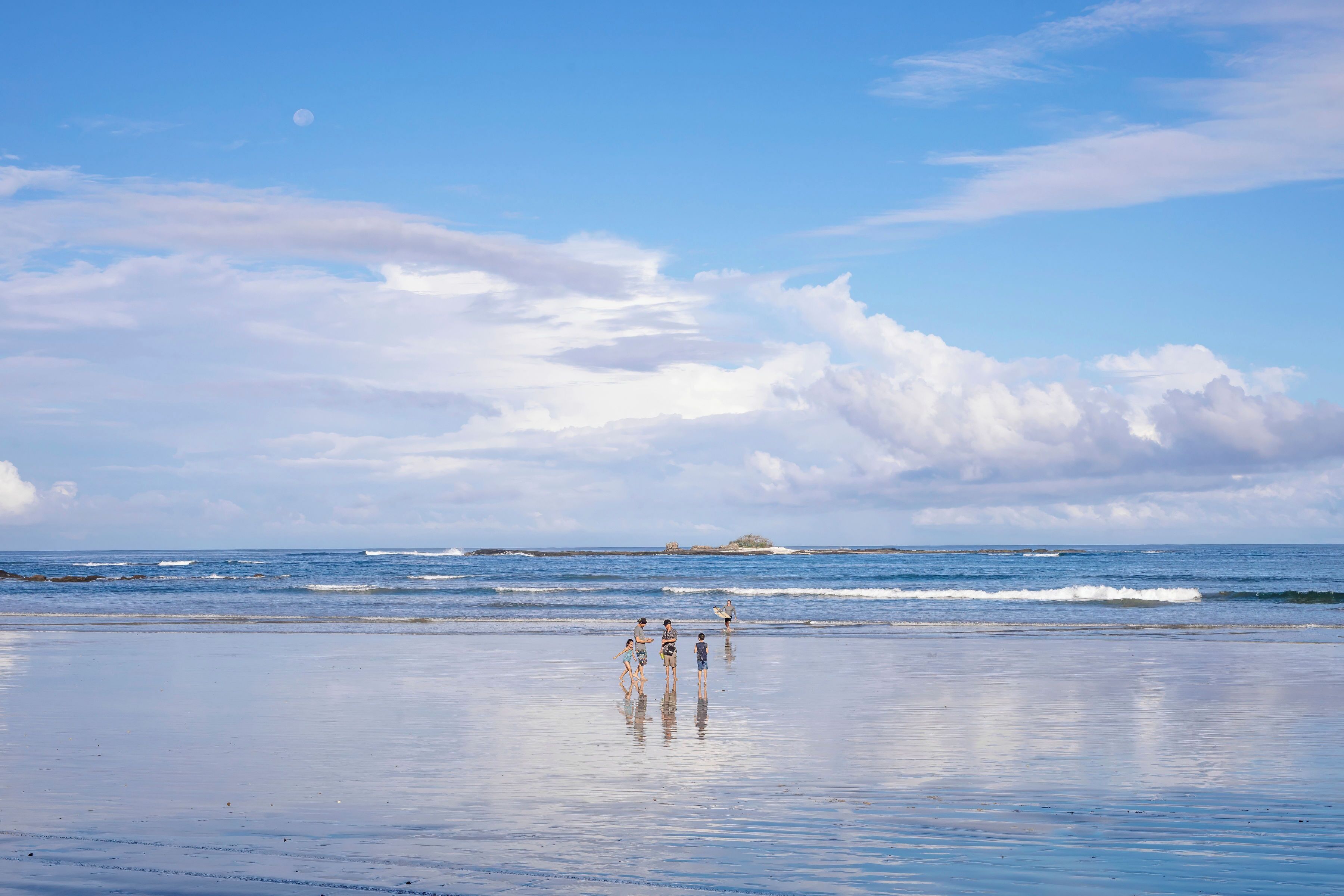 A beach with a clear sky and calm sea.