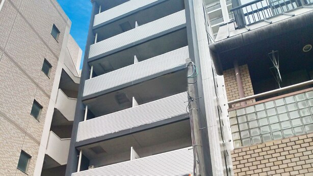 A multi-story building with a modern design, featuring a mix of brick and metal elements. - Residence Hotel Hakata 3 (Fukuoka)