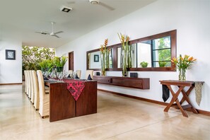 A spacious dining area with a long table, multiple chairs, and a wooden sideboard. - Mirissa Beach Villa (Thalaramba)