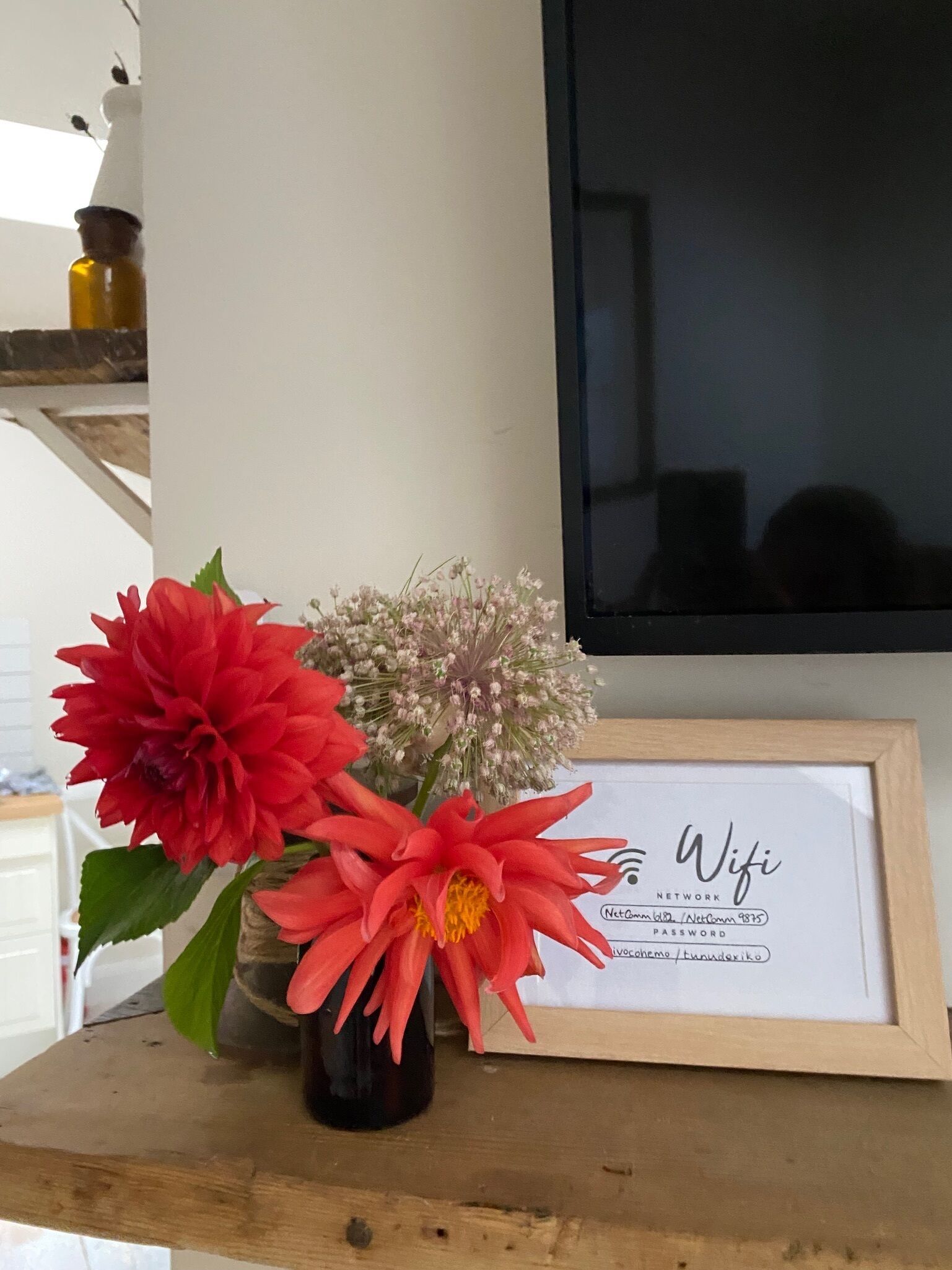A framed picture with a WiFi password on a wooden surface.
