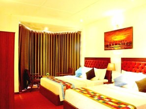 A hotel room with two beds, a large window with curtains, a painting on the wall, and a red carpet. - The Rosedale Grand Nuwara Eliya (Nuwara Eliya)
