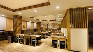 A spacious restaurant with wooden flooring, multiple tables and chairs, and a modern interior design. - Hotel Route - Inn Kumagaya (Kumagaya)
