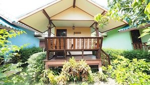 A traditional wooden house with a covered porch and a sign indicating a room number.