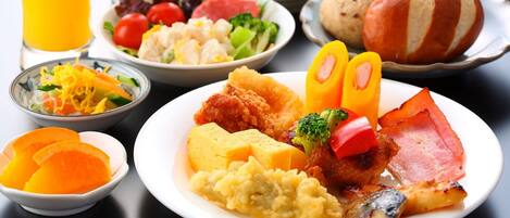 A breakfast spread with various dishes including eggs, bacon, and vegetables.