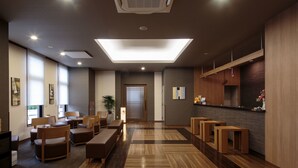 A modern hotel lobby with a reception desk, seating area, and a large illuminated ceiling. - Hotel Route - Inn Takaoka Ekimae (Takaoka)
