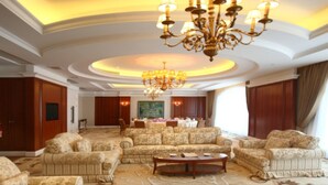 A spacious living room with a large chandelier, multiple sofas, and a coffee table. - Hotel Paris Pan-Island (Shanwei)